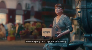 Amazon ad featuring a woman 35-54 waiting for her beau to give him a gift. He arrives and is delighted.